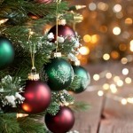 Christmas Tree, Red and Green Ornaments against a  Defocused Lights Background